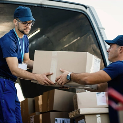 Smith Dray movers two people unloading boxes from a van