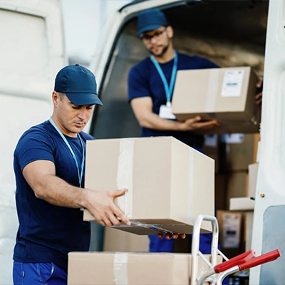 Smith Dray movers two people putting boxes on a cart